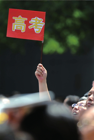 6月7日，在東直門考點(diǎn)外，一名家長手舉高考的小旗子迎接孩子。資料圖片本報(bào)記者王苡萱攝