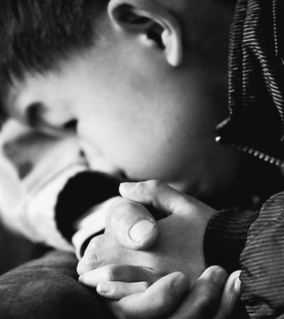 10歲小兒子緊緊握著哥哥的手。資料圖片